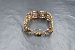 A 9ct gold six bar gate bracelet, having alternated textured and twist bars, with lobster clasp