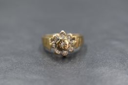 A 9ct gold diamond set cluster ring, the central diamond in an eight illusion diamond chip set