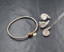 A silver cubic zirconia set necklace and earrings set, in a spiral motif, marked 925, along with a