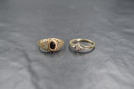 A 9ct gold sapphire set signet style ring, the oval cut sapphire in a bezel setting with pierced