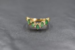 An 18ct gold emerald and diamond wishbone ring, the five marquise cut emeralds, total approx 0.