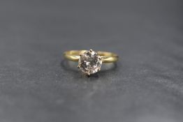 An 18ct gold diamond solitaire ring, the diamond being approx 1.28ct in a raised six claw set