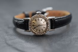 An 18ct white gold diamond set Omega wristwatch, the silver tone dial having baton five minute