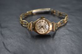 A 9ct gold cased Perona wristwatch, the champagne dial having Arabic numerals, on a rolled gold