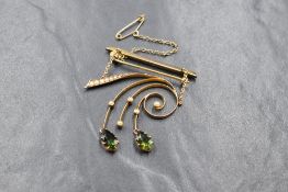 A 9ct gold green tourmaline and seed pearl set brooch, the bar brooch having a seed pearl set