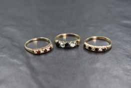 A 9ct gold sapphire and cubic zirconia set half eternity band, the four round cut sapphires