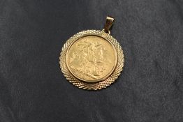 An Edwardian 1907 sovereign in a 9ct gold pendant mount, having decorative engraving, marked 9kt,