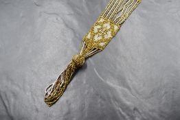 A belle epoque beaded sautoir necklace having gold and silver coloured metal beaded strands