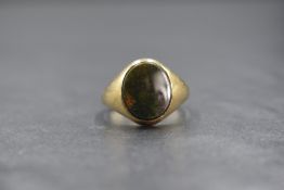 A 9ct gold bloodstone set signet ring, the central oval bloodstone in a bezel setting, marked 375,