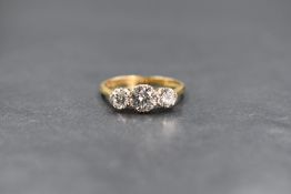 An 18ct gold diamond trilogy ring, the central brilliant cut diamond being approx 0.5ct flanked by