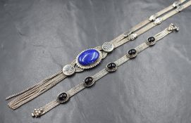 A white metal triple strand necklace stamped 900 having a central lapis lazuli oval cabochon with