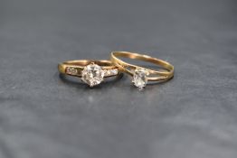 A 9ct gold cubic zirconia set ring, the central round brilliant cut cubic zirconia flanked by