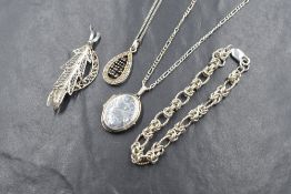Four pieces of silver jewellery including a fancy link bracelet, filigree leaf brooch, pendant and