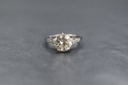 An 18ct white gold and platinum diamond set solitaire ring, the round brilliant cut diamond