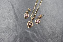 A 9ct gold ruby and diamond chip cluster pendant having a bright cut heart shaped mount on a 9ct