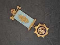 A 9ct gold Masonic 'Roll of Honor' medal, having an enamelled monogram and motto to the star burst