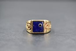 A 9ct gold lapis lazuli and sapphire set signet ring, the square lapis lazuli panel having an