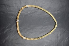 An 18ct gold diamond set Fope Gioielli necklace, the woven gold chain having three diamond set white