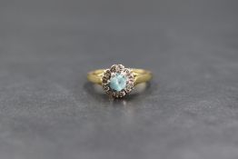 An 18ct gold zircon cluster ring having central damaged stone within an illusion set chip surround