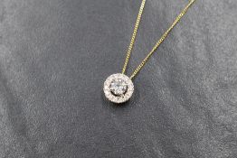 An 18ct gold and diamond halo pendant having a central brilliant cut diamond of approx 0.45ct within
