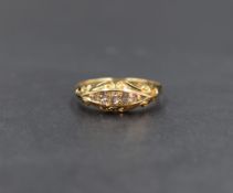 An 18ct gold diamond set five stone ring, the five graduated old cut diamonds, in a channel style