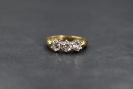 An 18ct gold diamond trilogy ring having three brilliant cut diamonds, approx 1ct total in a claw