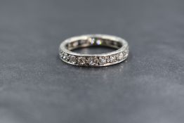 A white metal diamond set full eternity ring having twenty one pave set diamonds total approx 1ct,