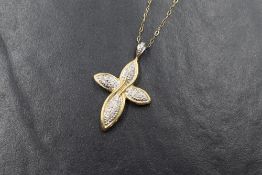 A 9ct gold diamond set cross pendant, the cross of rounded cross over form having pave set diamond