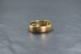 A 9ct gold band, of plain rounded form, marked 375, ring size U, 2.8g