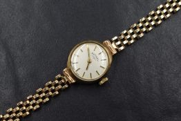 A ladies vintage 9ct gold wrist watch by Rotary having a baton numeral dial to champagne face in a