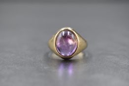 A 9ct gold amethyst set signet style ring, the central oval amethyst in a bezel setting, marked 375,
