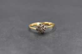 A yellow metal diamond chip set ring stamped 18ct having four small old cut diamonds in a star