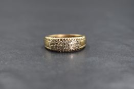 A 9ct gold diamond set band, the pave set diamond chips in three rows, marked 375, ring size O-P,