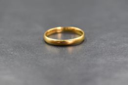 A 22ct gold band, of plain rounded form, marked 22 with hallmarks, ring size M-N, 2.1g