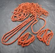 A small selection of coral jewellery including a carved bead necklace and bracelet, a pair of triple
