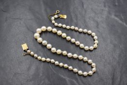 A knotted string of graduated cultured pearls having a 9ct gold decorative box clasp, approx 16'