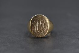 A gent's yellow metal signet ring bearing monogrammed oval cartouche, ring has been resized with
