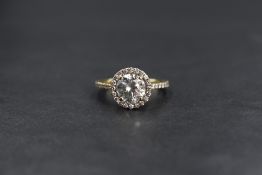 A yellow metal diamond halo ring having a central diamond approx 1.33ct within a diamond halo