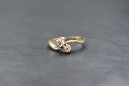 A 9ct gold diamond & paste crossover ring in claw set mount, crossover shoulders and 9ct gold