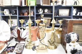 Two 20th-century brass candelabra-style table lamps; sold with a resin draping swag and ribbon-motif