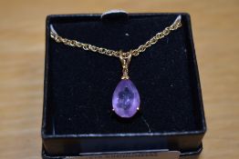 An amethyst and diamond chip set pendant, the pear cut amethyst measuring approximately 3ct, with