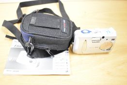 A Fujifilm Finepix A303 point and shoot digital camera, with users manual and a Lowepro carry case.