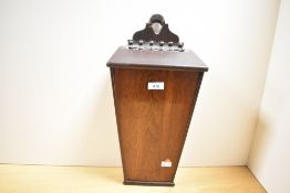 A 19th century oak candle box, of tapering trapezoidal form with leather hinged sloping cover and