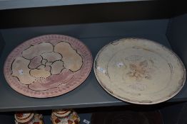 Two decorative 20th-century Kenyan carved soapstone chargers, featuring incised swimming fish