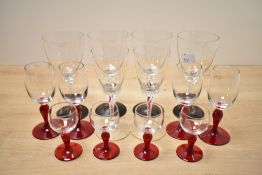 A quantity of 20th-century studio art glassware, comprising eight short cranberry-stemmed aperitif/