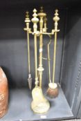 A good quality cast brass pedestal companion set, comprising a central pedestal stand with four '