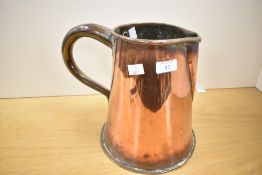A large late 19th to early 20th-century hand crafted copper jug, having a large rounded handle,