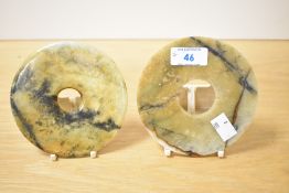 A pair of Chinese carved variegated stone Bi/Yubi type discs, of circular form with central