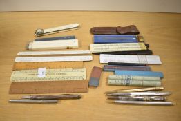 A box of various rules, Slide rules, six mechanical pencils including Eversharp, Lifelong (
