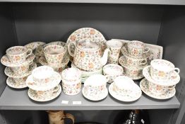 A 20th-century Minton bone china 'Haddon Hall' tea service, featuring a multi-coloured floral and
